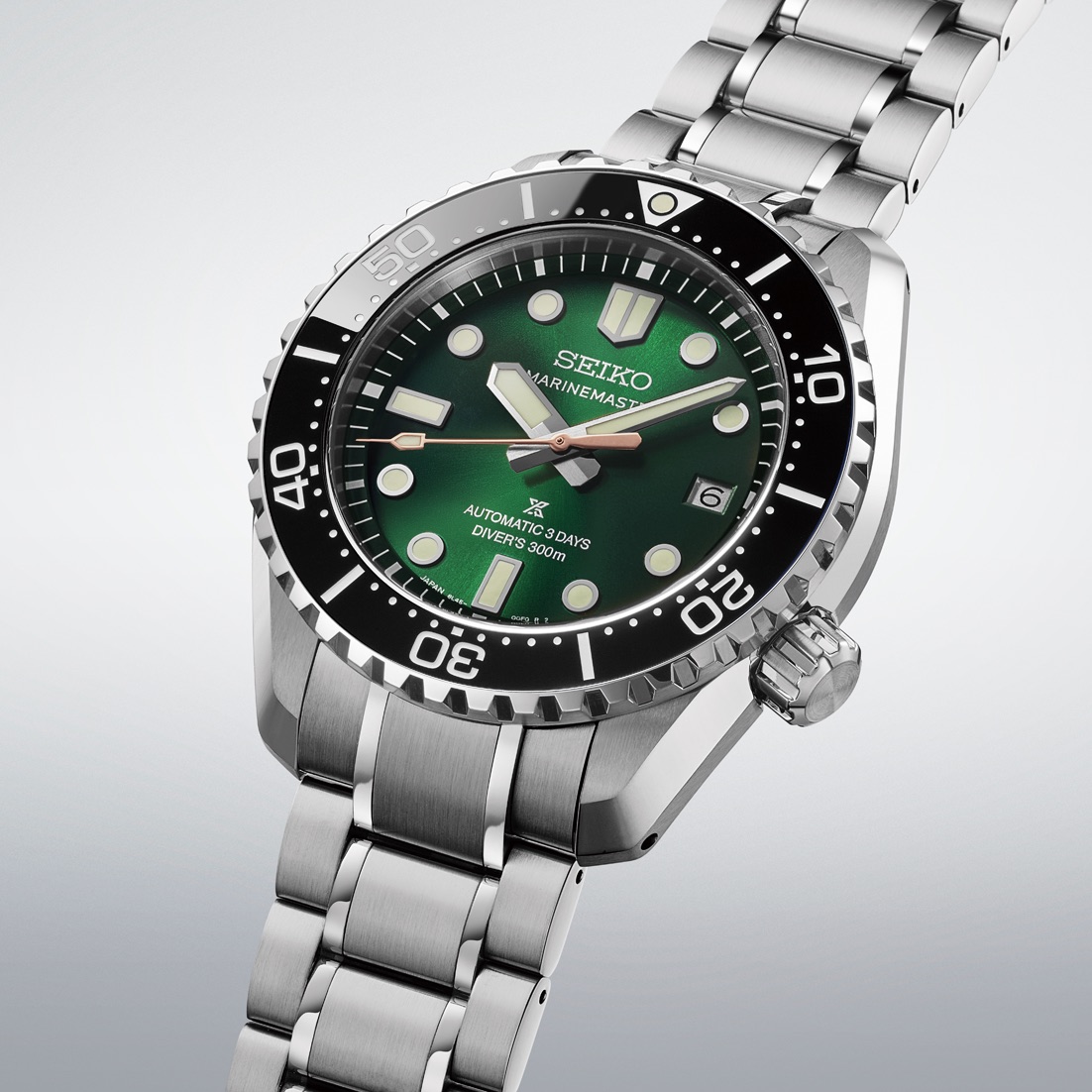 Three-quarter view of the green Seiko HBF003 on its steel bracelet